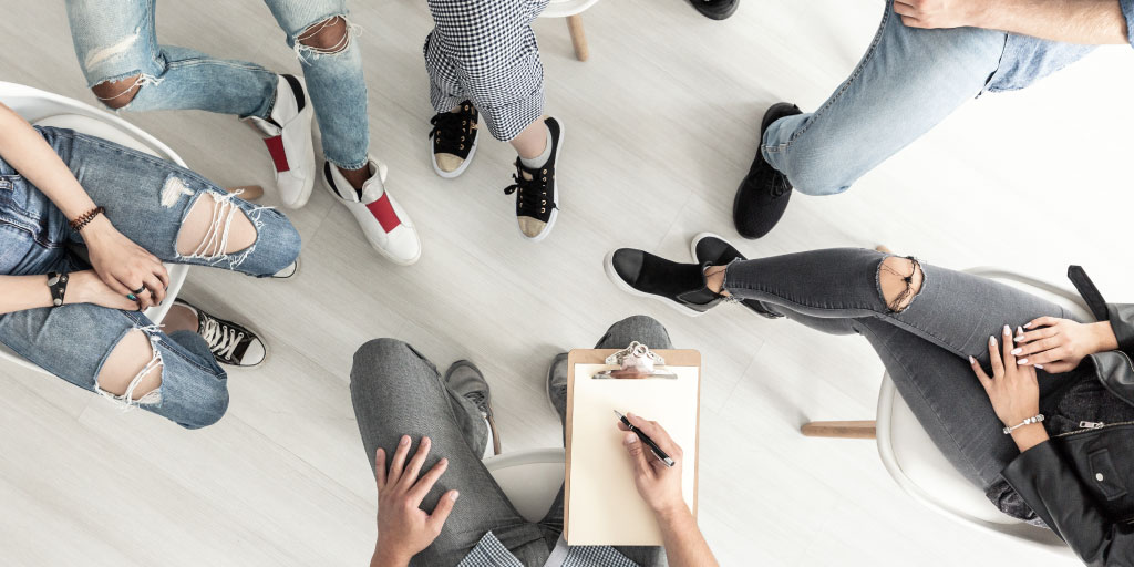A group of people in a circle during a groups session.